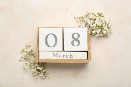 Calendar with date of International Women's Day and flowers on light backgroundの写真素材