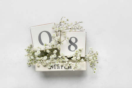 Calendar with date of International Women's Day and flowers on white backgroundの写真素材