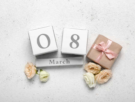 Calendar with date of International Women's Day and flowers on light backgroundの写真素材