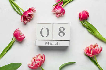 Calendar with date of International Women's Day and flowers on white backgroundの写真素材