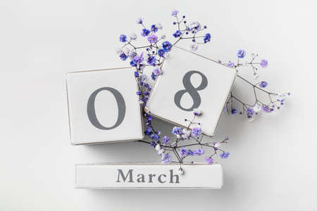 Calendar with date of International Women's Day and flowers on white backgroundの写真素材