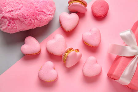Tasty heart-shaped macaroons on color backgroundの写真素材