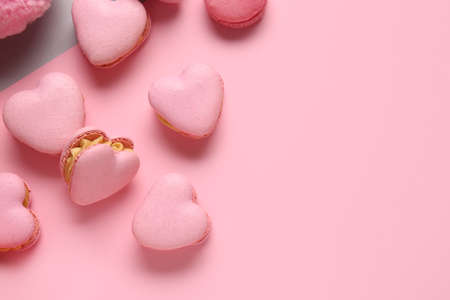 Tasty heart-shaped macaroons on color backgroundの写真素材