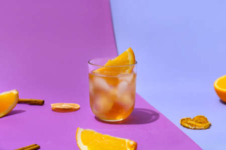 Glass of delicious Old Fashioned Cocktail on color backgroundの写真素材