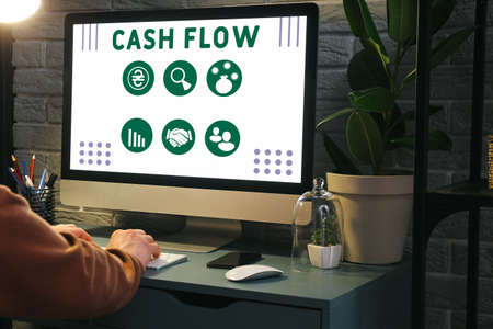 Man working on computer in dark room. cash flow