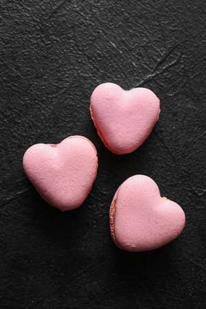 Tasty heart-shaped macaroons on black backgroundの写真素材