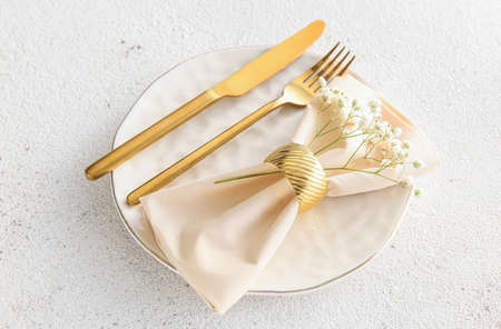 Simple table setting with flowers on light background
