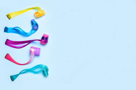 Different color hair strands with curlers on blue backgroundの写真素材
