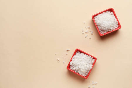 Bowls of sea salt on color backgroundの写真素材