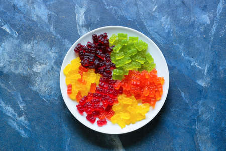 Plate with sweet jelly bears on blue backgroundの写真素材