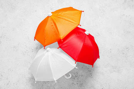 Different mini umbrellas on light backgroundの写真素材