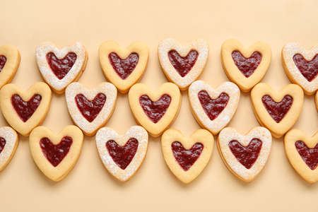 Tasty cookies in heart shape on beige backgroundの写真素材