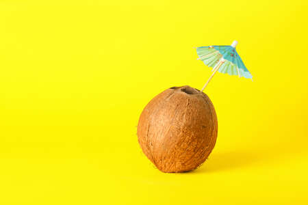 Tasty cocktail in coconut on yellow backgroundの写真素材