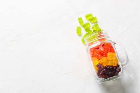 Mason jar with sweet jelly bears on light backgroundの写真素材