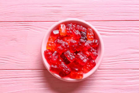 Plate with sweet jelly bears on wooden backgroundの写真素材