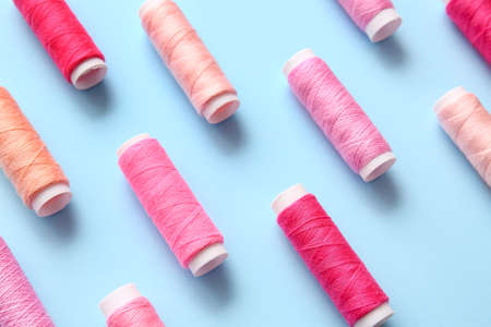 Thread spools on blue backgroundの写真素材