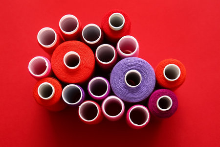 Thread spools on red backgroundの写真素材