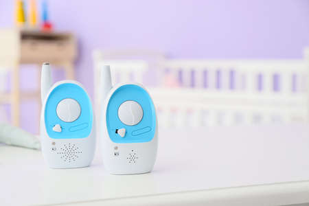 Modern baby monitors on table in room