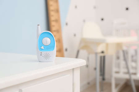 Modern baby monitor on table in roomの写真素材