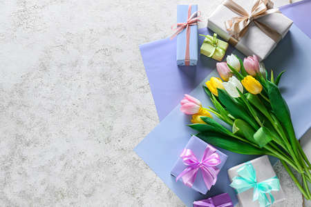 Composition with gift boxes and flowers for International Women's Day celebration on light...