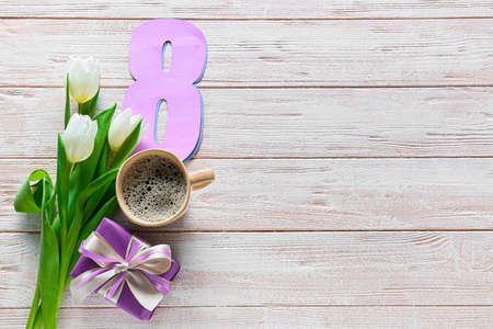 Composition with gift box, flowers and cup of coffee for International Women's Day celebration on...