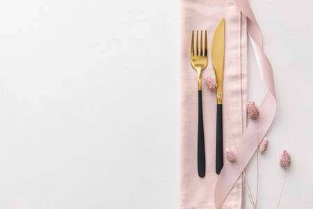 Elegant cutlery and lagurus flowers on light backgroundの写真素材