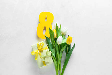 Composition with gift boxes and flowers for International Women's Day celebration on white...