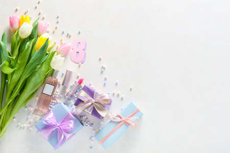 Composition with gift boxes, flowers and cosmetic products for International Women's Day celebration...