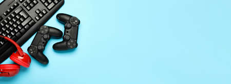 Modern gaming accessories on blue background with space for textの写真素材