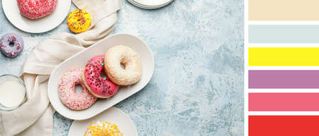 Many sweet donuts on light blue background. different color patternsの写真素材