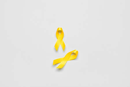 Golden awareness ribbons on light background. International Childhood Cancer Dayの写真素材