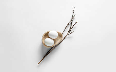 Composition with Easter eggs and pussy willow branches on light background