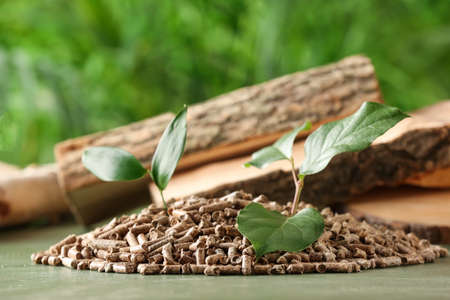 Pile of wood pellets on table outdoors, closeup