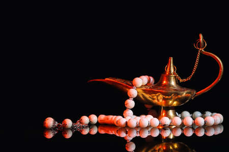 Muslim lamp and prayer beads on dark backgroundの写真素材