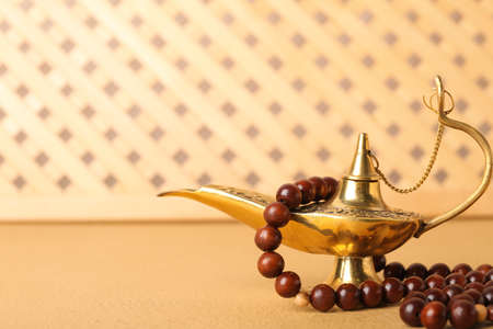 Muslim lamp and prayer beads on tableの写真素材