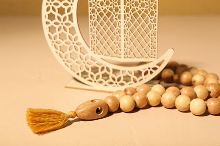 Decorative crescent and Muslim prayer beads on color backgroundの写真素材