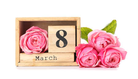 Calendar and flowers for International Women's Day celebration on white background