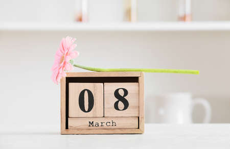 Calendar and flower for International Women's Day celebration on table in kitchenの写真素材