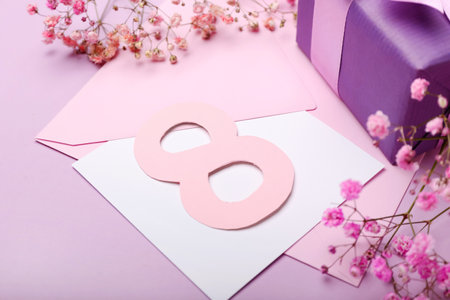 Composition with figure 8, gypsophila flowers and envelope for International Women's Day celebration...