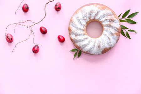 Plate with tasty Easter cake and eggs on pink backgroundの写真素材