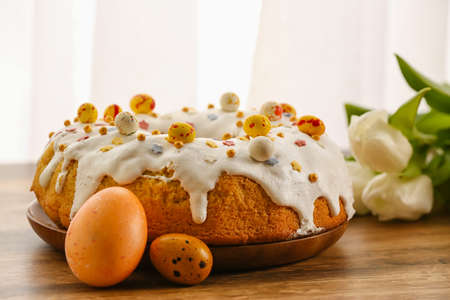 Plate with tasty Easter cake and eggs on table