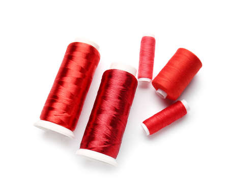 Different thread spools on white background