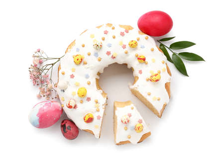 Tasty Easter cake, eggs and gypsophila flowers on white background