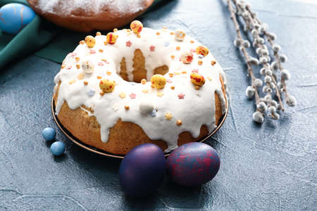 Plate with tasty Easter cake and eggs on black backgroundの写真素材