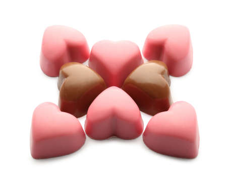 Composition with tasty candies in shape of hearts on white background