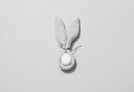 Easter bunny napkin fold with egg on gray backgroundの写真素材