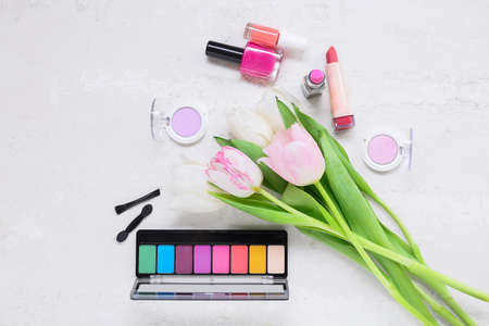Composition with decorative cosmetics and tulips for International Women's Day celebration on grunge backgroundの写真素材