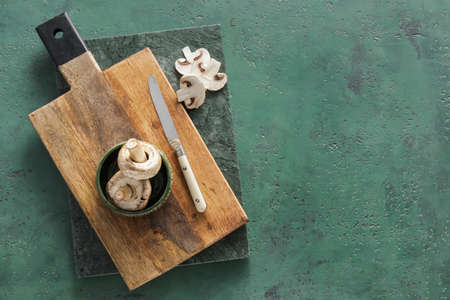 cutting boards and mushrooms on green backgroundの写真素材