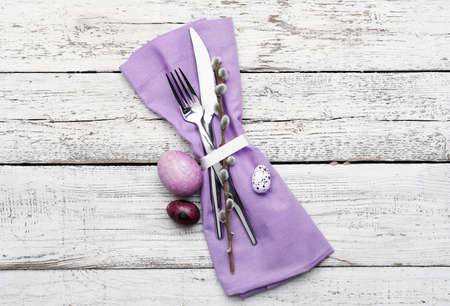 Stylish cutlery for Easter celebration on light wooden backgroundの写真素材