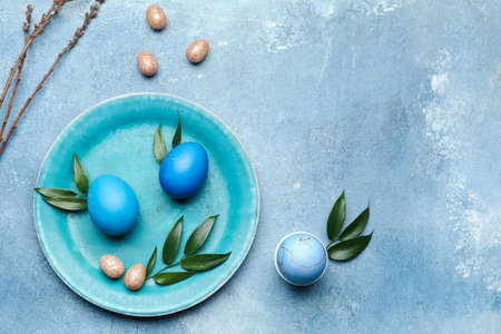 Stylish table setting for Easter celebration on grunge backgroundの写真素材